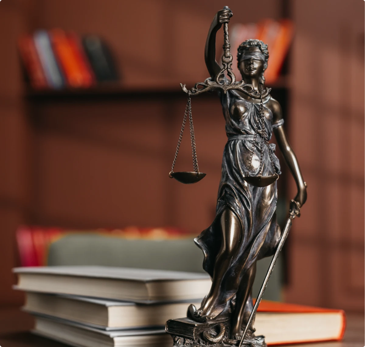 Justice statue beside stacked books